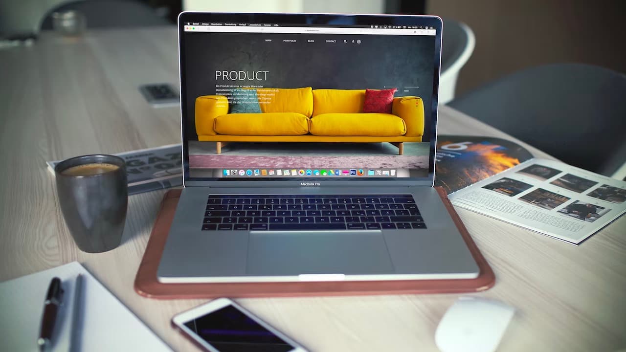 laptop desk phone coffee workplace office igormiske unsplash