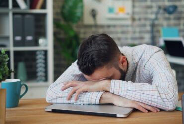 man vila utmattad trott skrivbord unsplash